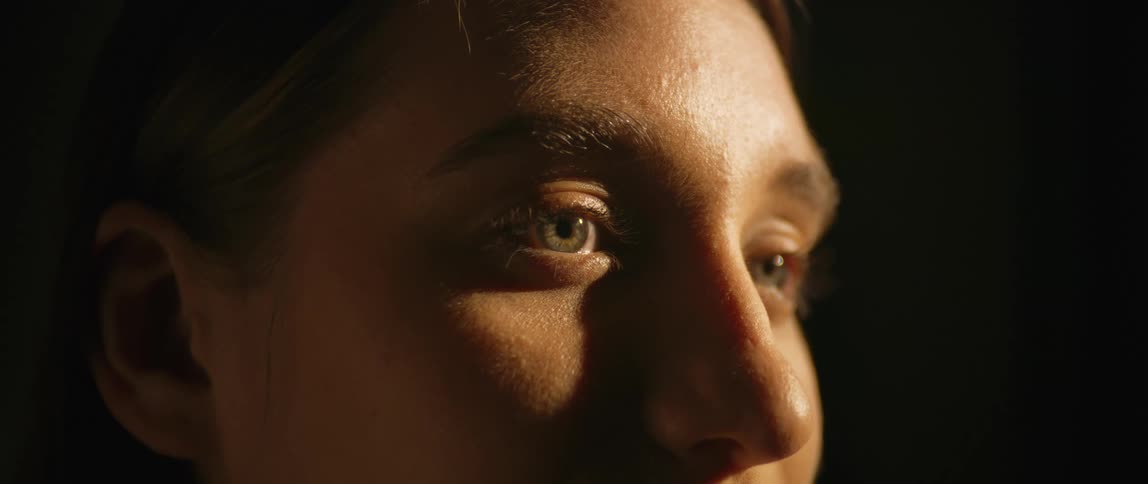 Close up of a persons face with a beam of natural light