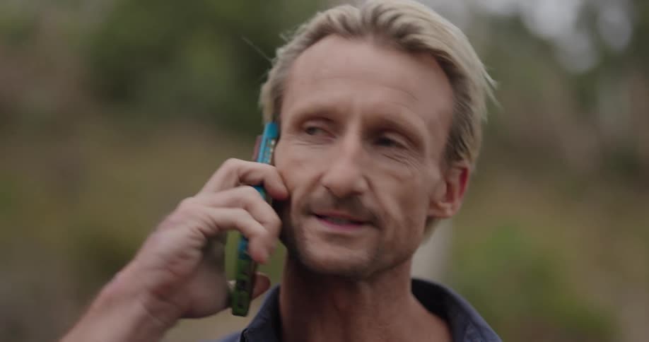 Man standing outside talking on his cell phone