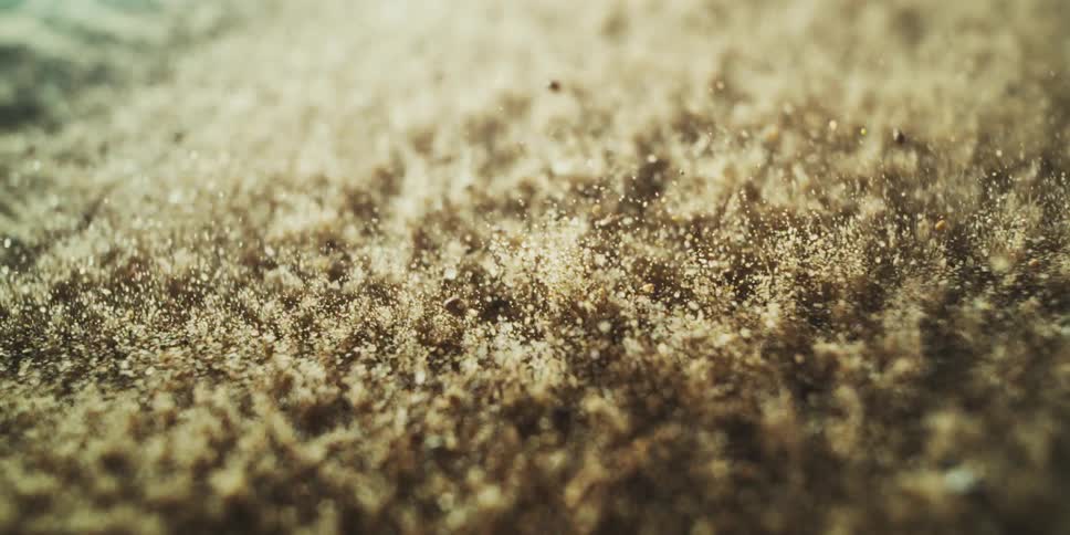 Sand and pebbles vibrating on a membrane when exposed to sound