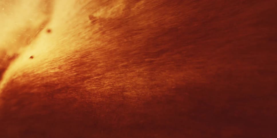 Fiery particles and embers blister past camera in intense visceral inferno