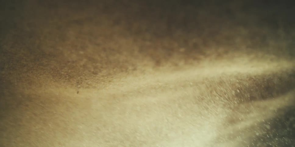 Inverted Wave of Sand and Rock Crashing Into the Ground and Lens