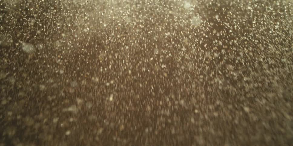 Pale Silver Particles Falling Like a Weightless Waterfall