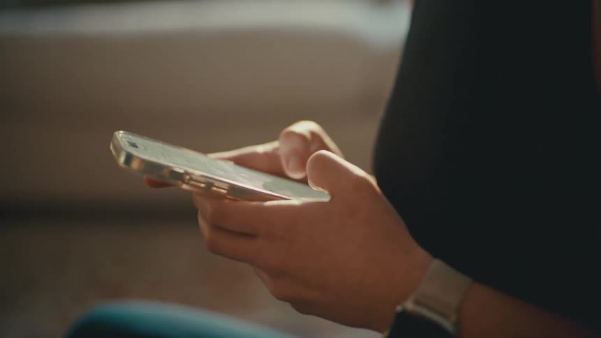 A woman is texting on her cell phone