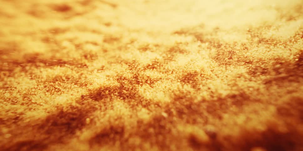 Red and gold particles vibrate under a barrage of explosive charges