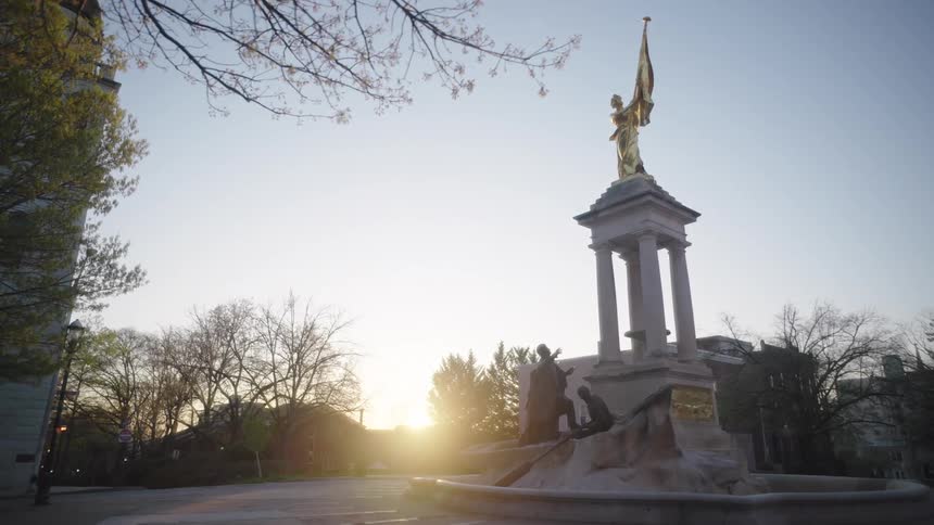 The sun is rising on the large statue