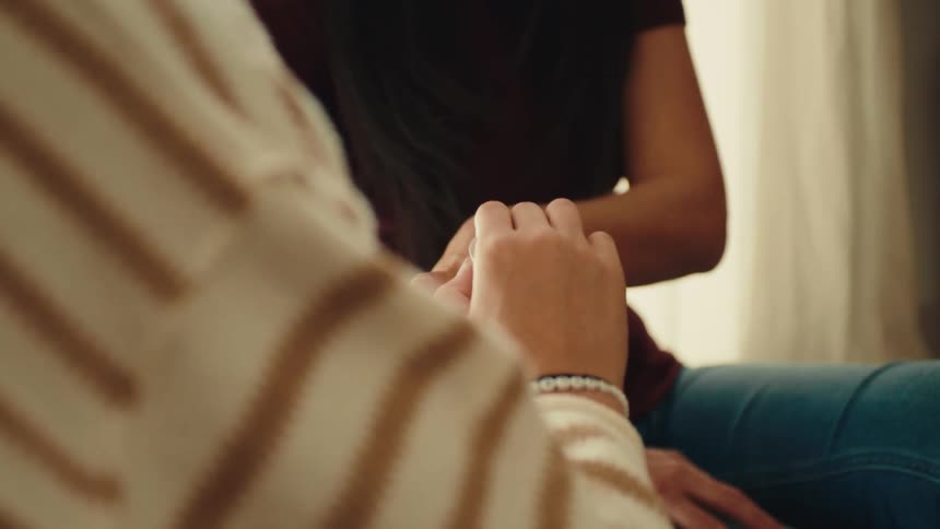 A woman paints her friends nails