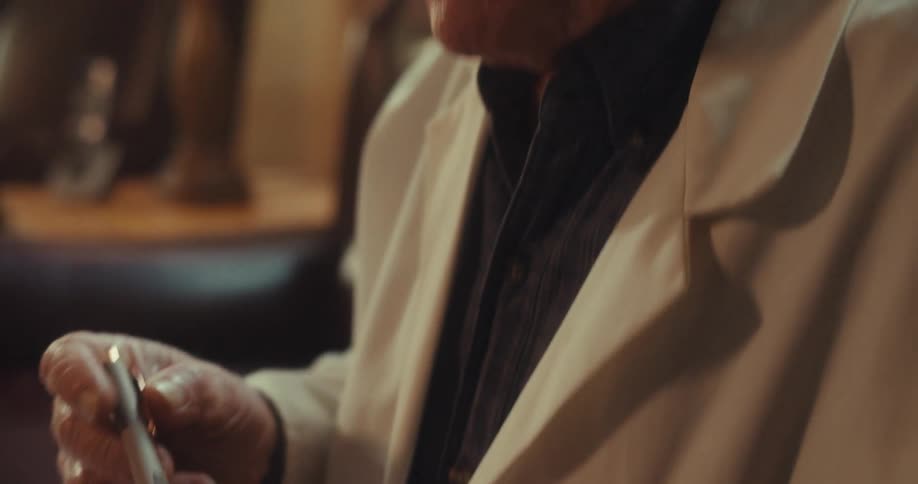 The doctor is talking while holding a clipboard with a form on it