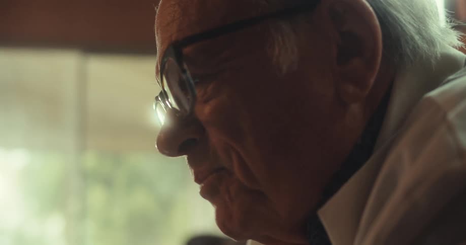 An elderly doctor explaining something to a patient