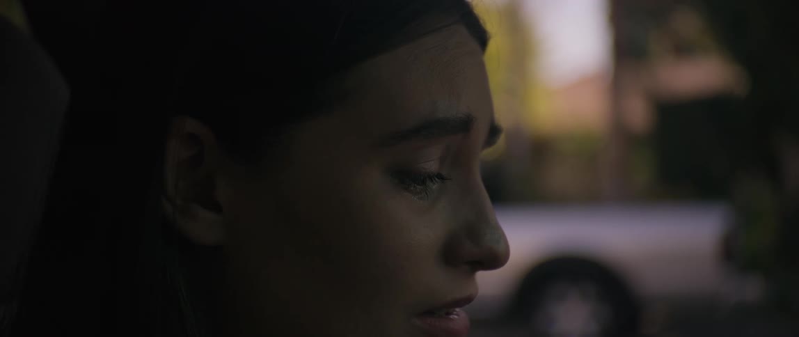 Close up face of a lady crying inside the car at daytime