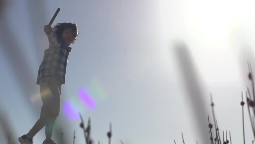 A kid playing on a sand dune