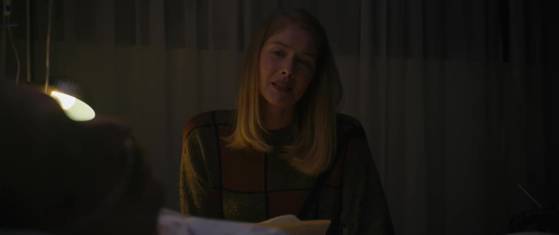 Woman tries to keep from crying while visiting a patient in the hospital