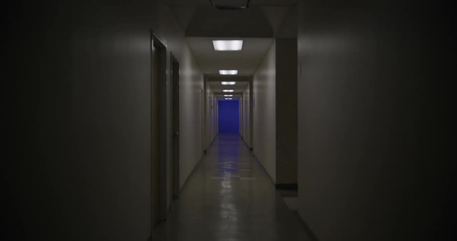 Lights of a narrow corridor turning on