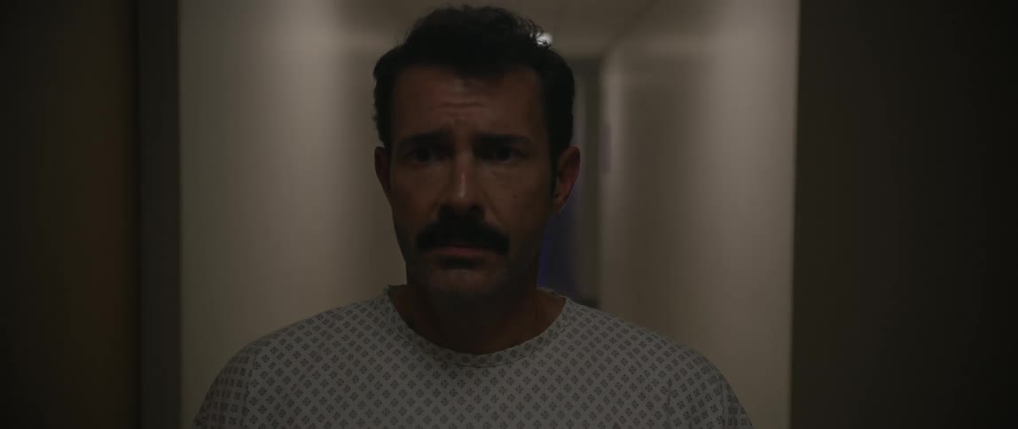 Man in a hallway with the lights going out