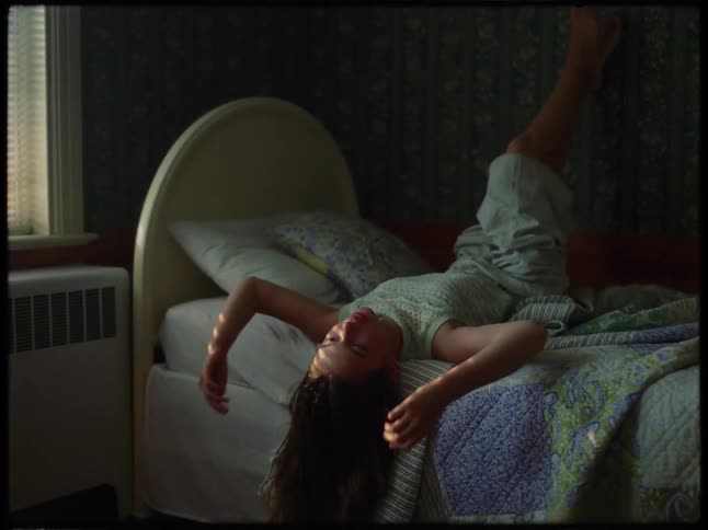 A woman is relaxing in bed