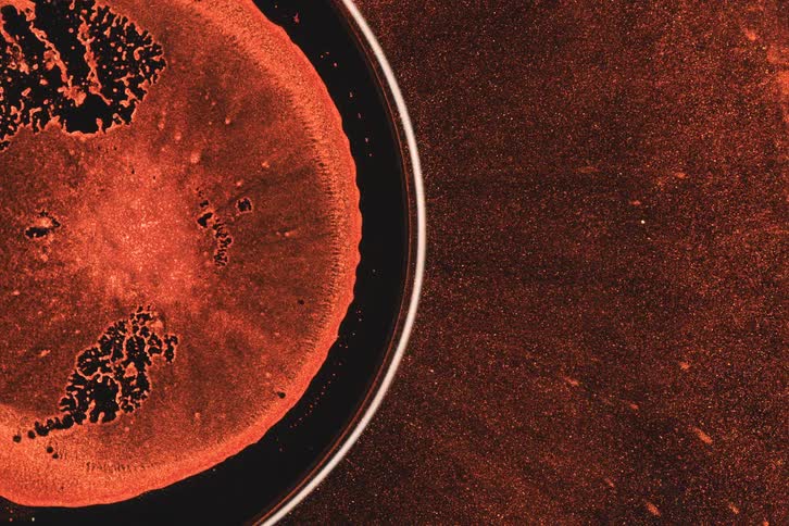 The red ink is flowing and moving by the sphere