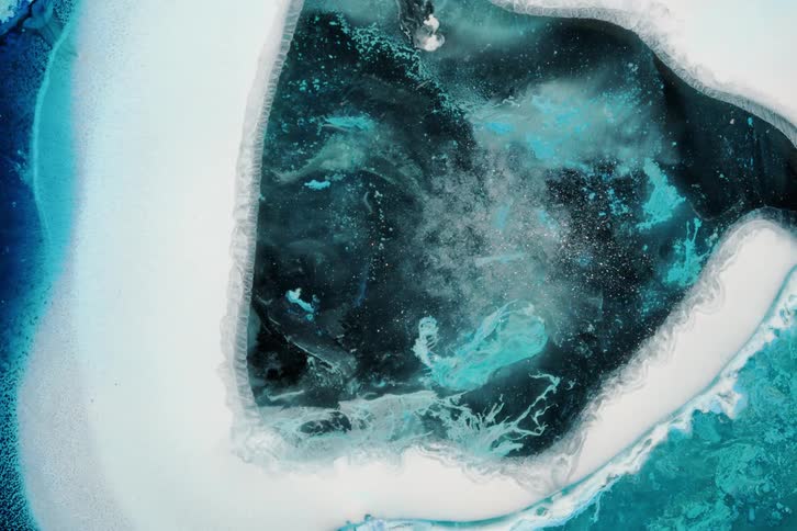 White layer moves outward creating an empty space with a churning center against a blue and black background