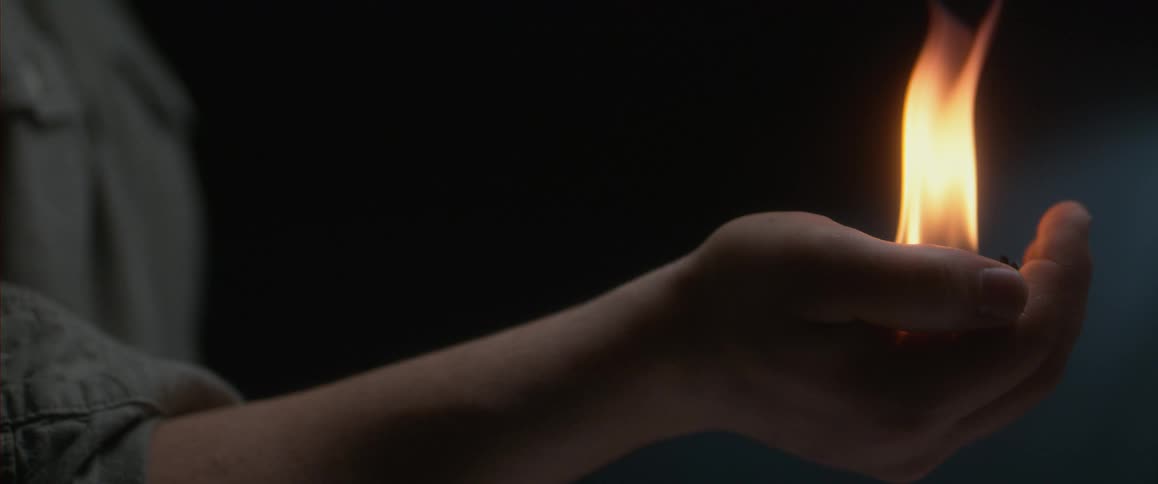 A person holding fire in their palm