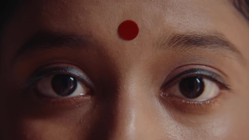 The indian woman blinks her eyes slowly