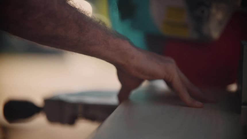 Man using a table saw outdoors