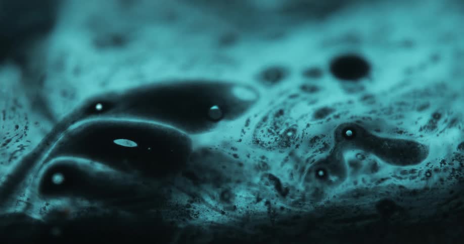 The dark ink moves around in a pattern