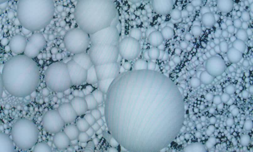 Disorganized patterned white spheres in a loop against a black background