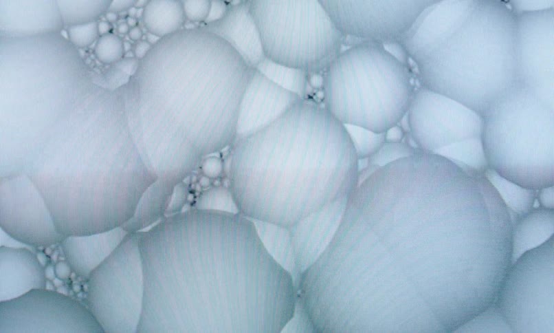 White colored patterned balls in abstract motion