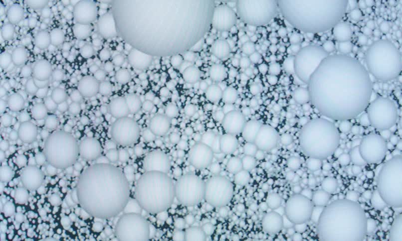 Several white spheres grouped in different sizes on a dark background
