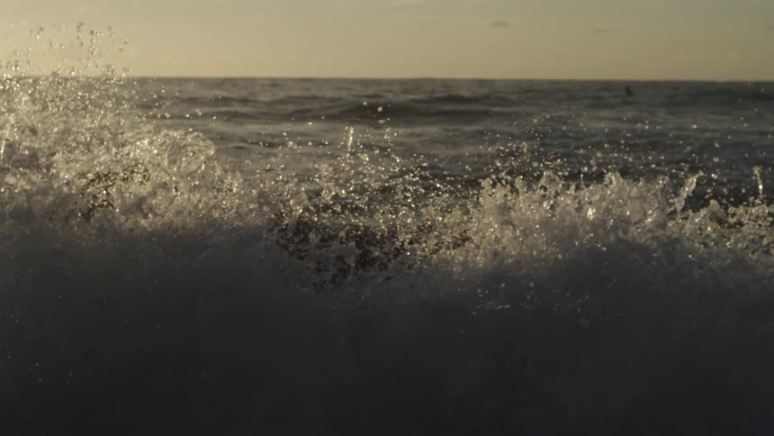 The lave wave crashes down splashing everywhere