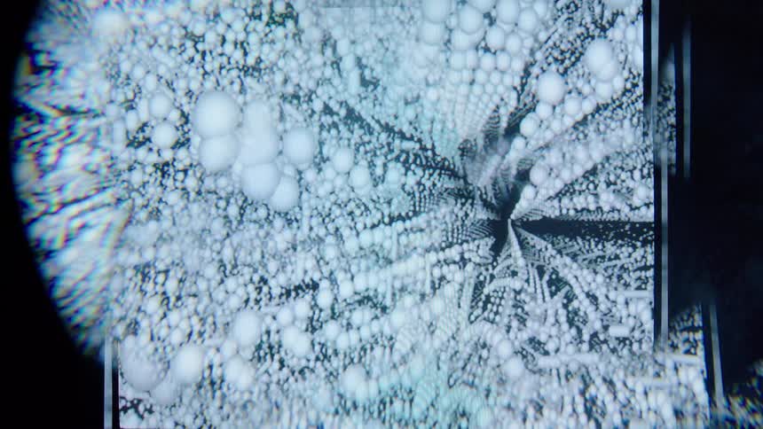 An abstract computer generated tunnel of morphing 3d spheres creates a surreal scifi visual experience