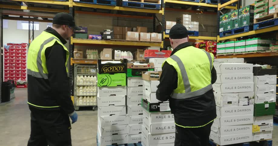 The workers are taking notes and checking inventory