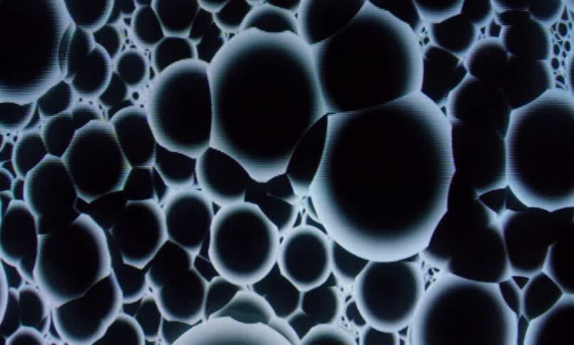Standardized black spheres against a whitish background