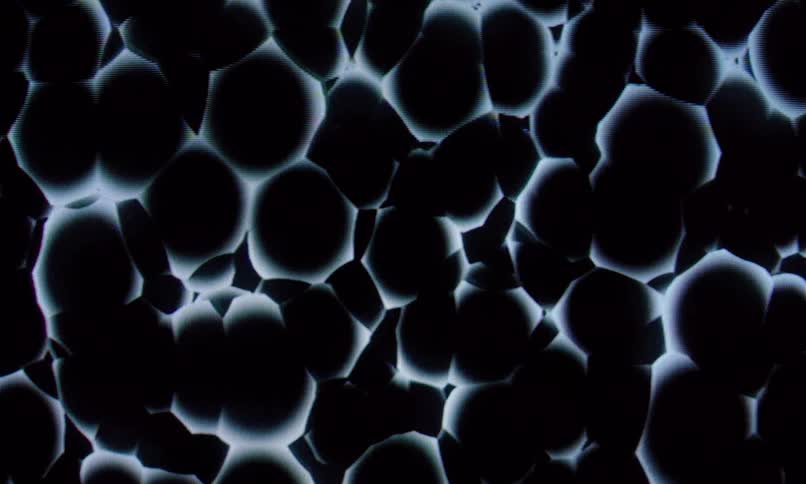 The screensaver is full of black orbs bouncing around