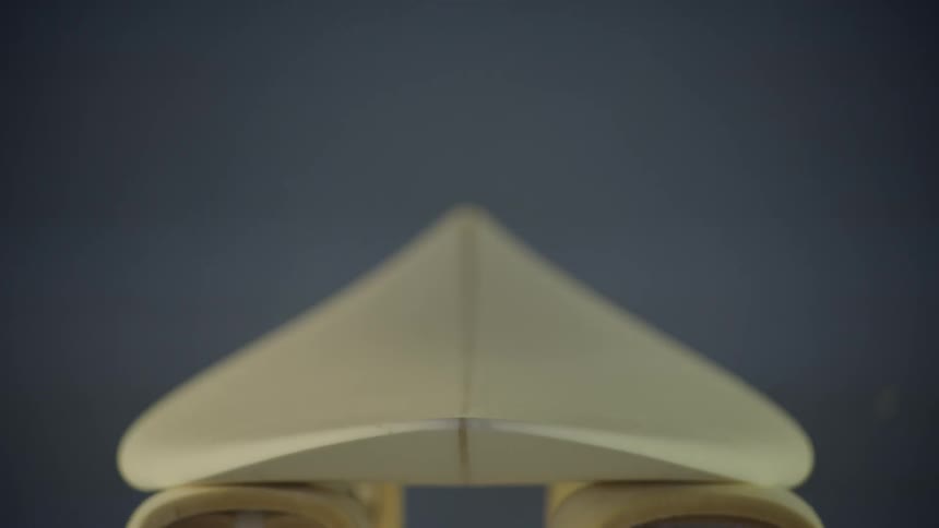 A surfboard is sitting on foam-covered bars