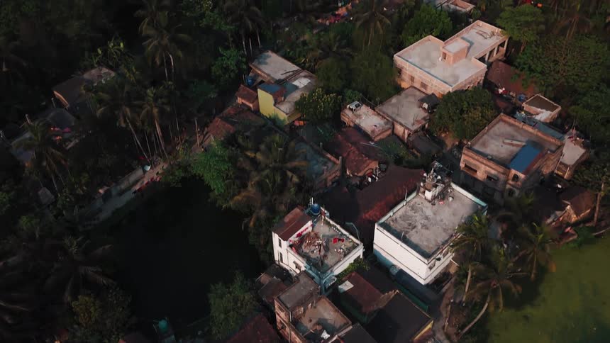 Aerial shot of a community in a rural area with a lake in the background