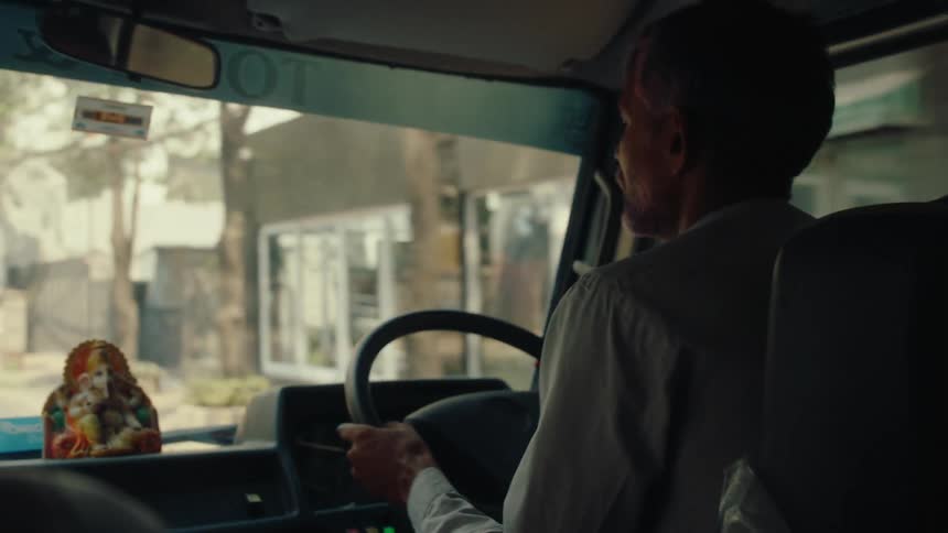 A man driving his van through the city