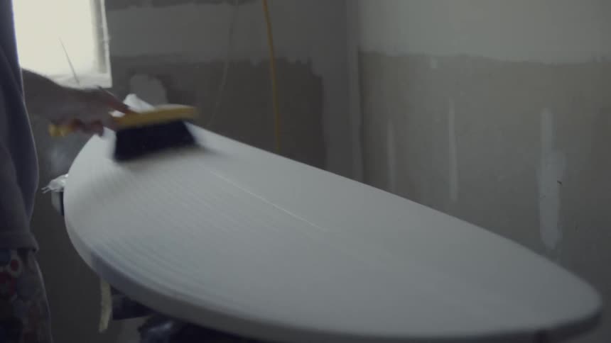 Person sanding a large oval shaped piece of wood