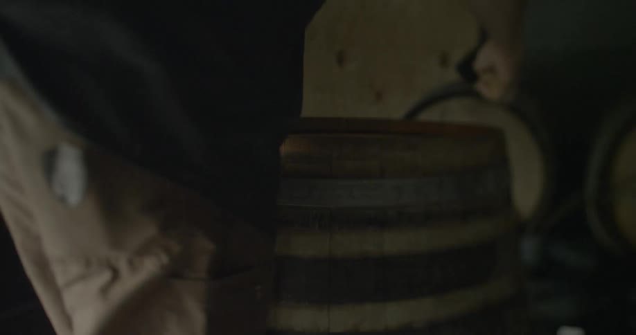 A man pries open a barrel