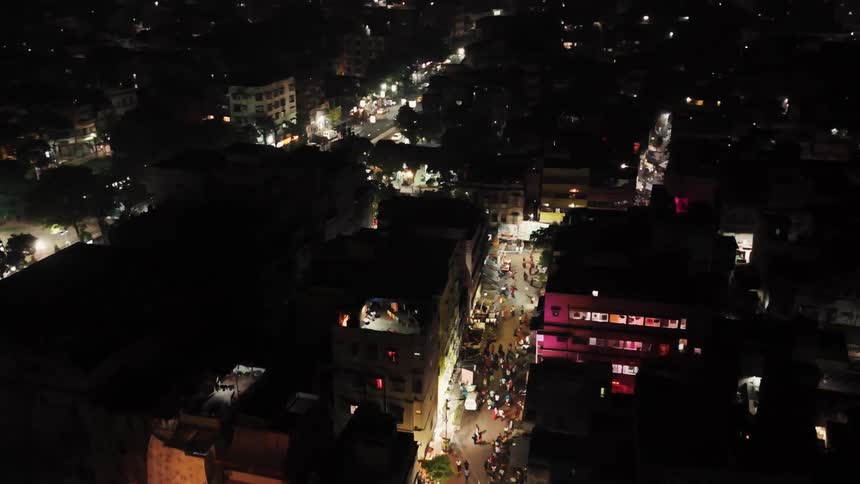 Aerial of a busy street and buildings in a city at night