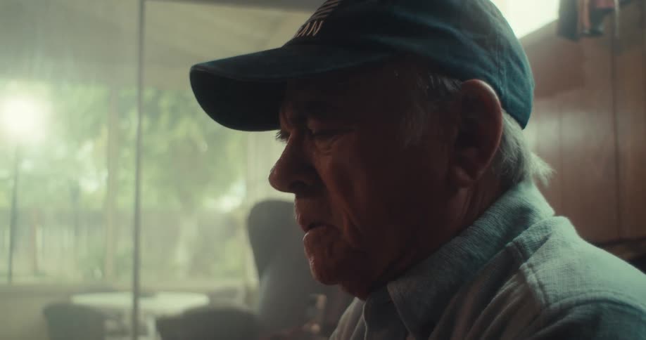 Man in cap looking thoughtful