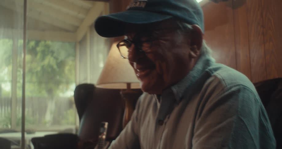 Elderly man watching a game on a tablet and cheering