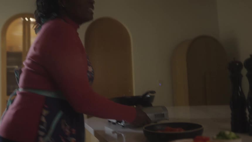 Woman talking and cooking