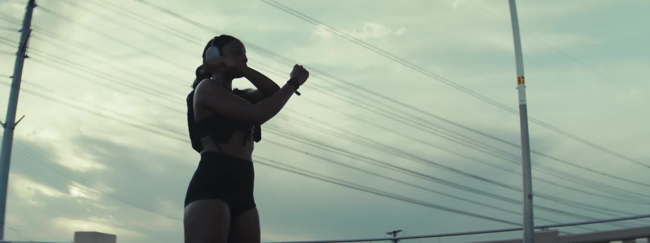 A female runner is stretching her arms before starting her running