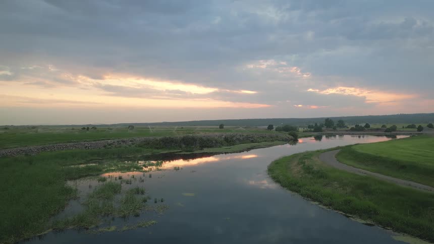 Landscape of a dammed creek winding through a rural area