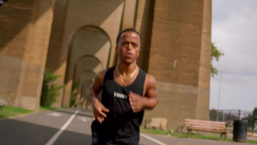Dwarf in black tank top running outdoors