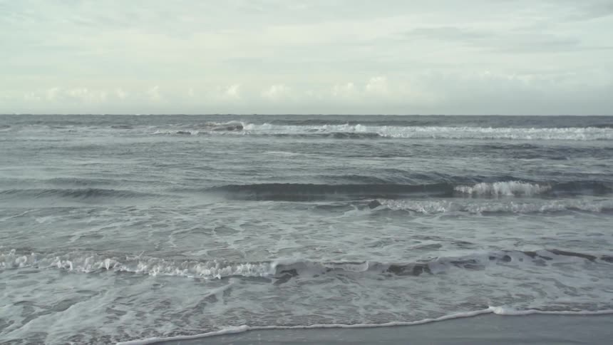 Waves come ashore on a beach