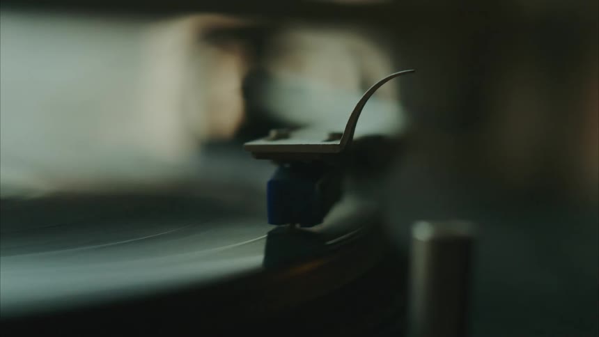 Hand handling a vinyl music playing object