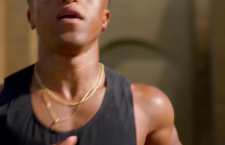 Man with determined expression running