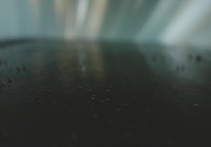 A closeup view of a circuit board with intricate patterns and components illuminated by soft light reflections