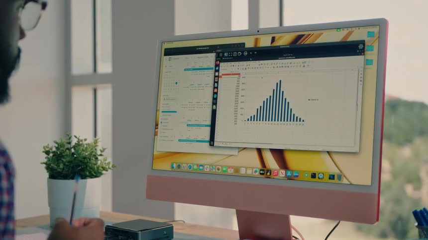 Man interacts with graph displayed on computer screen