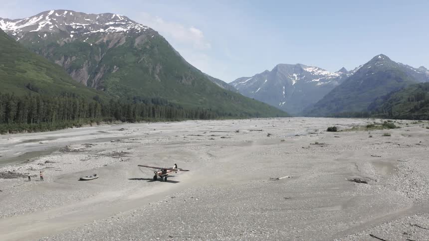 A plane lands near the mountains